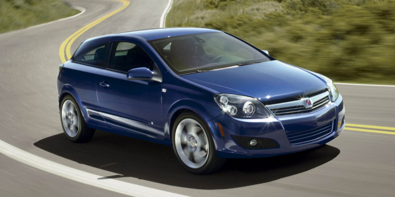 Discontinued Saturn vehicle driving through a highway.